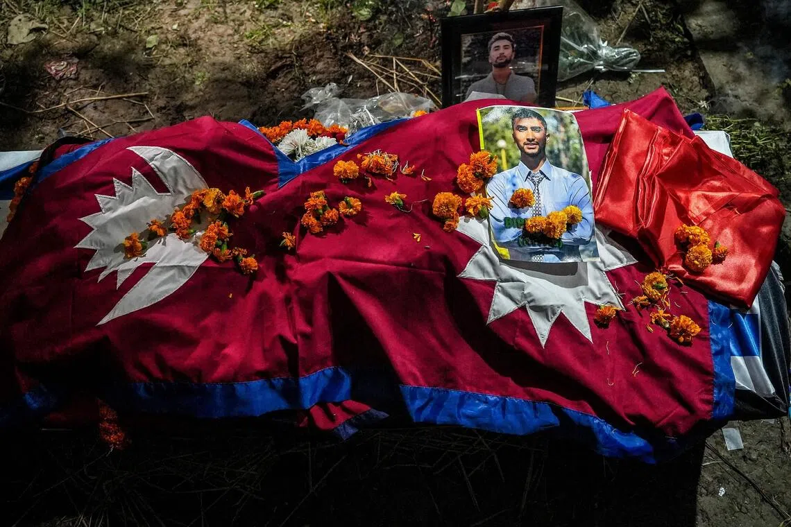 The coffin of Mr Bipin Joshi, a deceased Nepali agricultural student who died while being held hostage in Gaza by the Palestinian militant group Hamas, is seen shrouded in Nepal's national flag after its arrival at his residence in Kanchanpur on Oct 20.