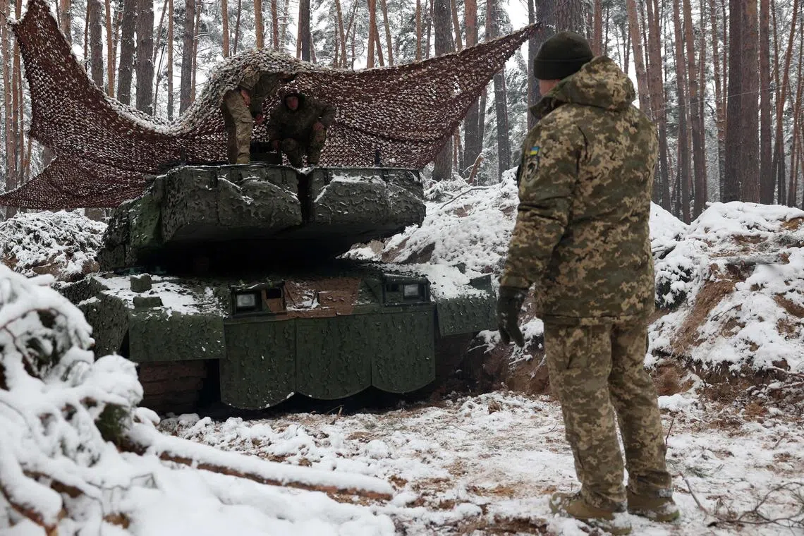 Ukrainian troops with a German-made Leopard battle tank in Ukraine's Donetsk region.