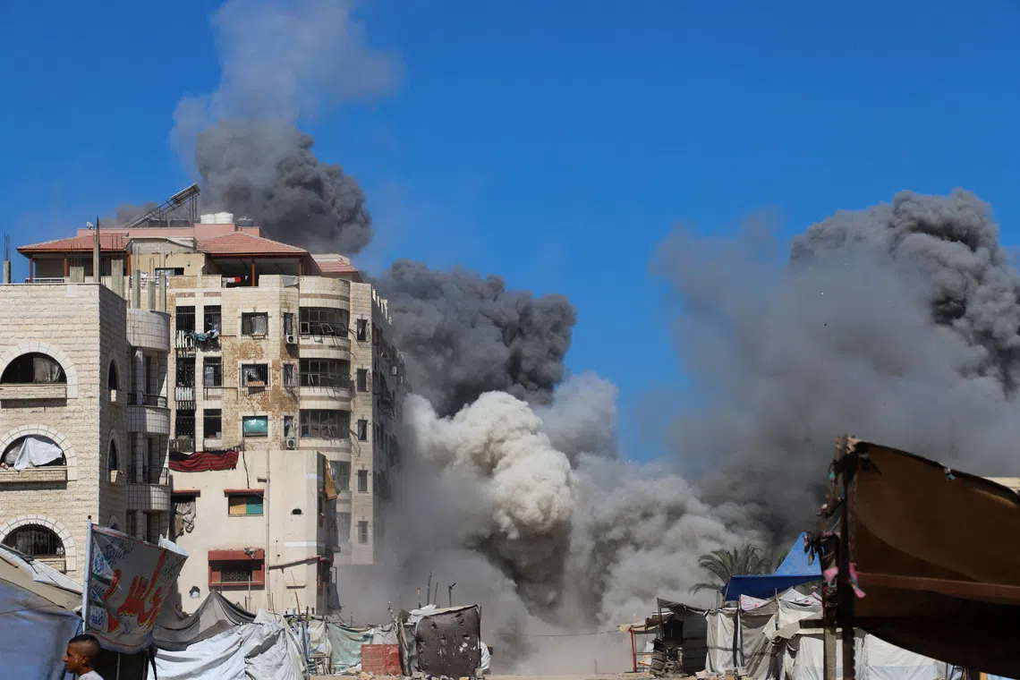 FILE PHOTO: Smoke rises from an evacuated residential building which was housing displaced Palestinians after it was hit by an Israeli air strike, in Gaza City, September 14, 2025. REUTERS/Ebrahim Hajjaj/File Photo