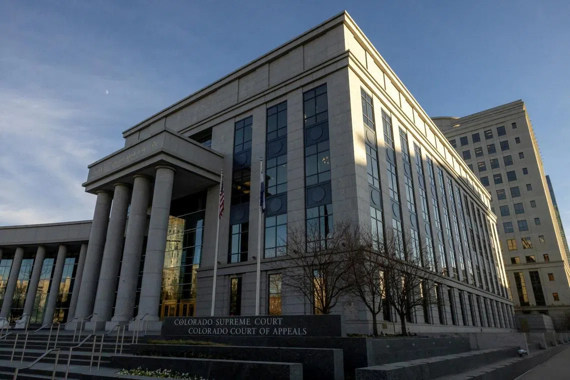 An intruder at the Colorado Supreme Court in Denver surrendered to police after firing shots in the building and holding an unarmed security guard at gunpoint.