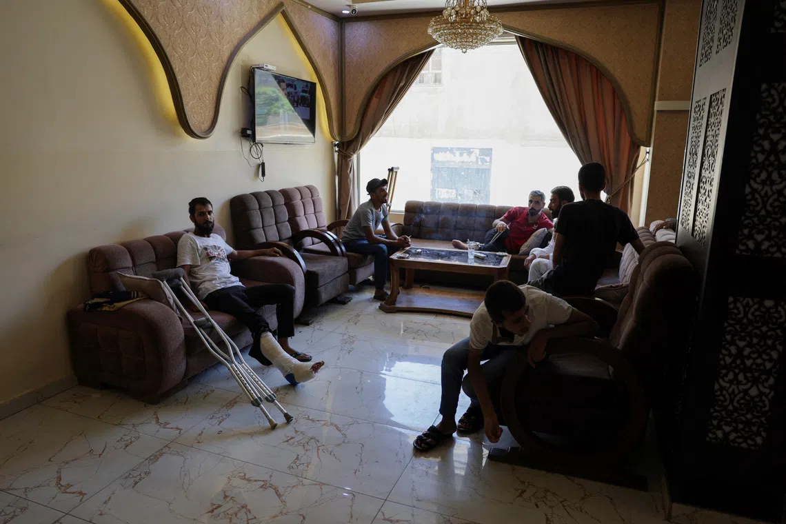 A group of Bedouins who fled sectarian fighting in Syria's Sweida province sits inside a hotel where they took shelter in Damascus, Syria, August 5, 2025. REUTERS/Khalil Ashawi