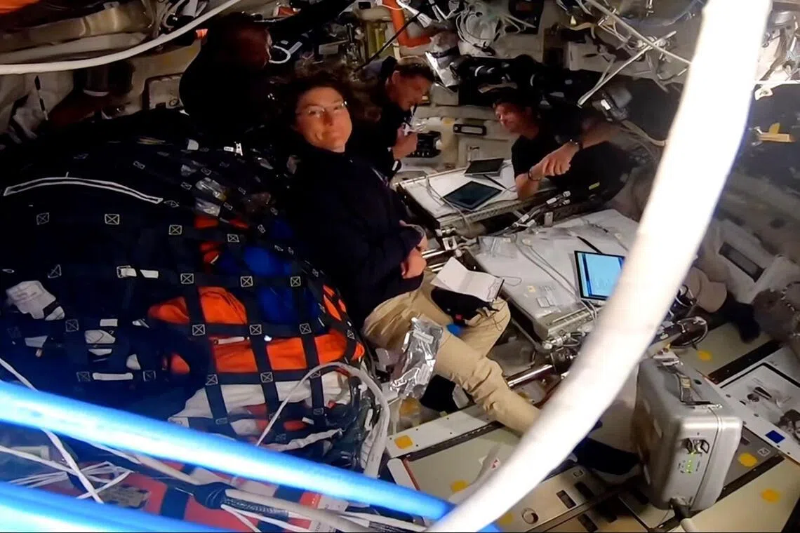 A video screengrab taken from a NASA livestream shows Artemis II crew members aboard the Orion Integrity spacecraft on April 6.