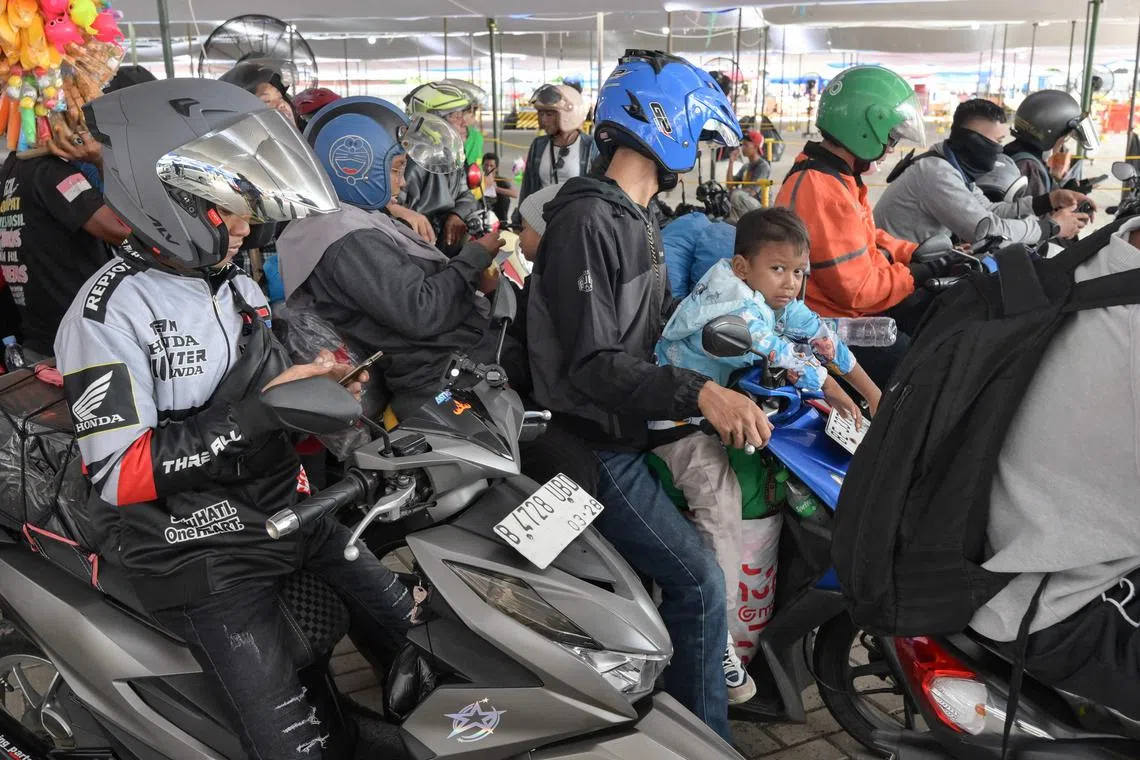 Motorcyclists wait to board the ferry at Ciwandan Port in Cilegon, Banten, on March 28.