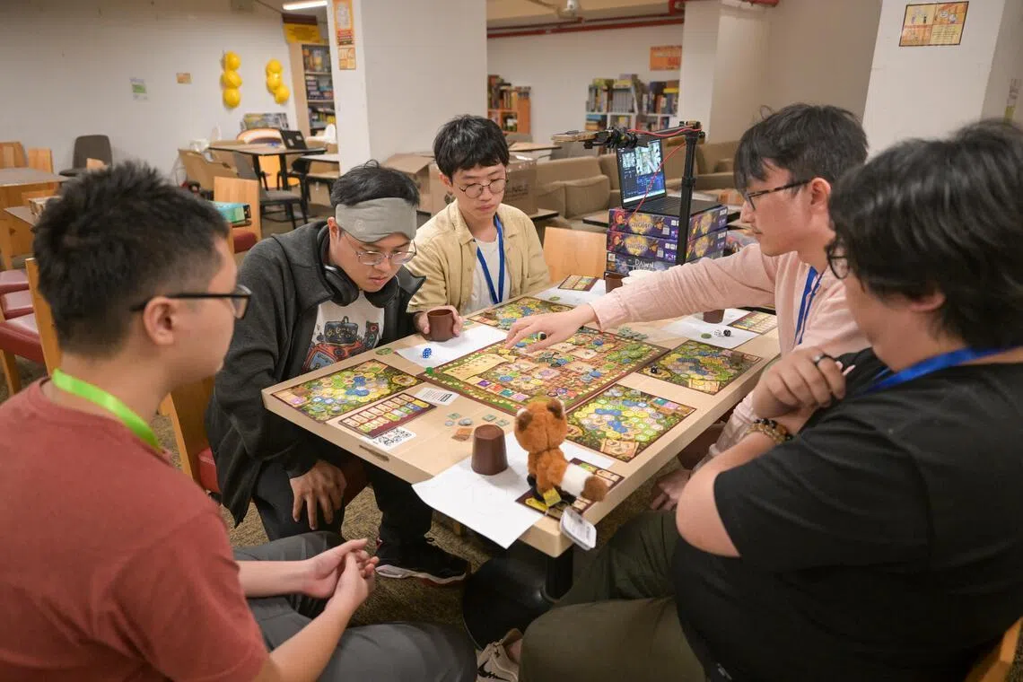 Players participating at the World Series of Board Gaming Singapore satellite event final game at The Mind Cafe Mega Store on June 2, 2025.