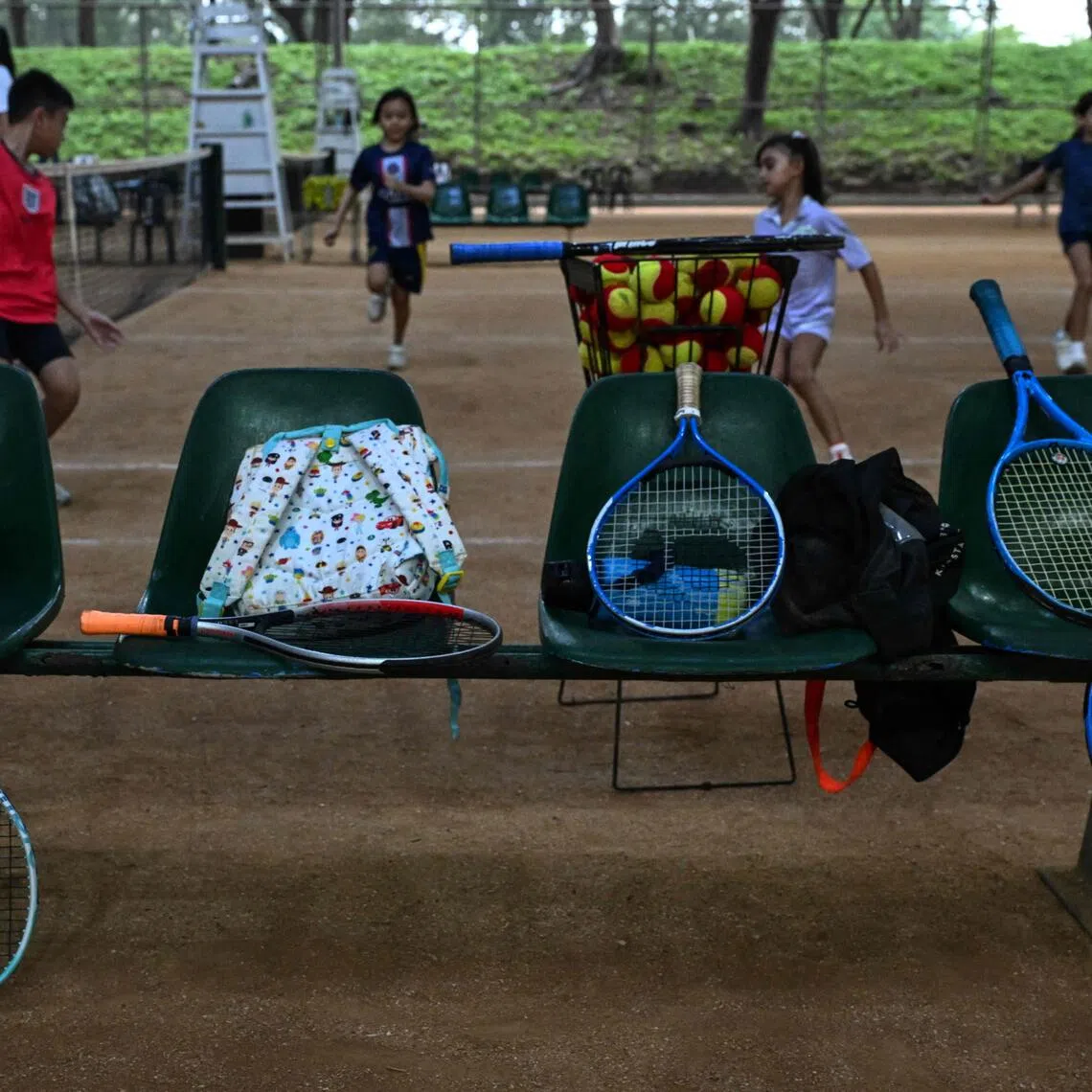 This photo taken on Aug 7 shows tennis rackets on a bench as children take part in a training session at Alabang Tennis Academy in Muntinlupa, Metro Manila.
