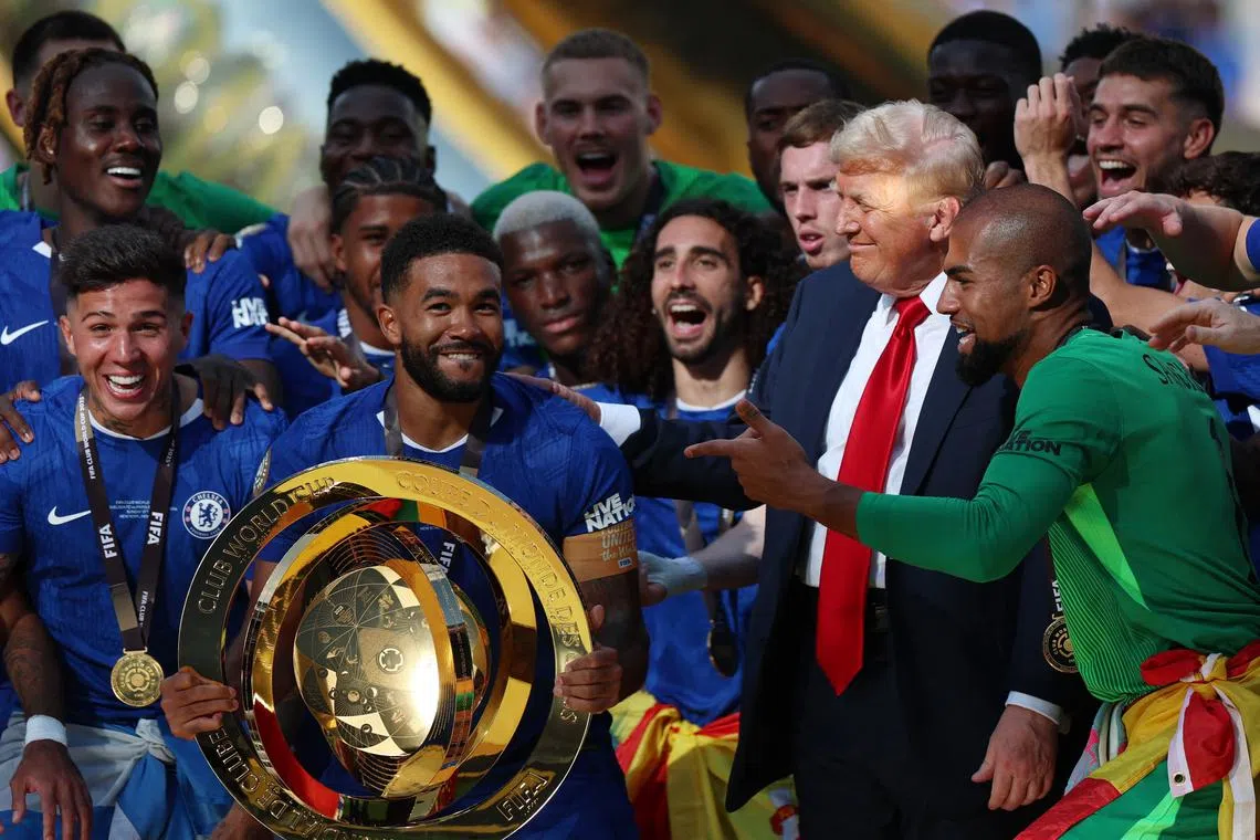 Soccer Football - FIFA Club World Cup - Final - Chelsea v Paris St Germain - MetLife Stadium, East Rutherford, New Jersey, U.S. - July 13, 2025 Chelsea's Reece James and teammates celebrate with the trophy alongside U.S. President Donald Trump after winning the FIFA Club World Cup REUTERS/Hannah Mckay