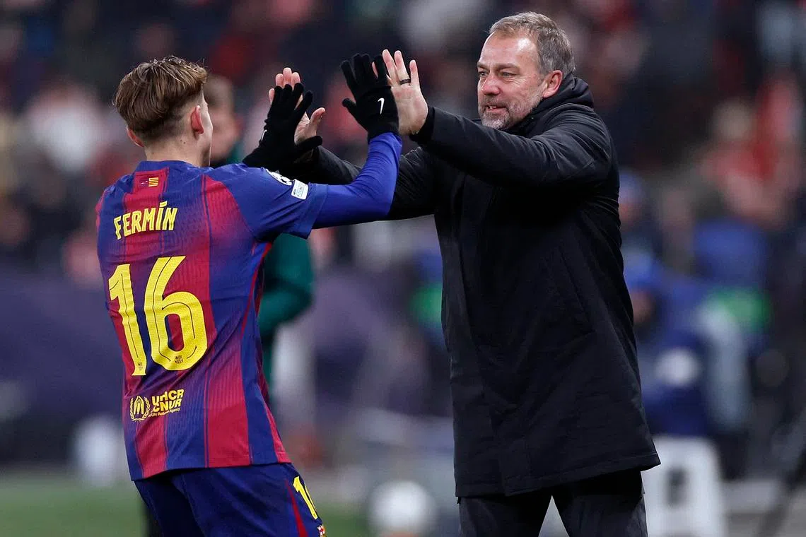 Soccer Football - UEFA Champions League - Slavia Prague v FC Barcelona - Fortuna Arena, Prague, Czech Republic - January 21, 2026 FC Barcelona's Fermin Lopez celebrates scoring their second goal with FC Barcelona coach Hansi Flick REUTERS/David W Cerny