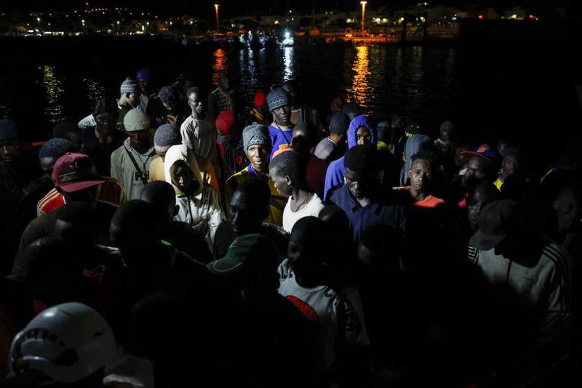 Migrants wait to disembark from a Spanish coast guard vessel, in the port of Arguineguin, on the island of Gran Canaria, Spain October 24, 2023. REUTERS/Borja Suarez