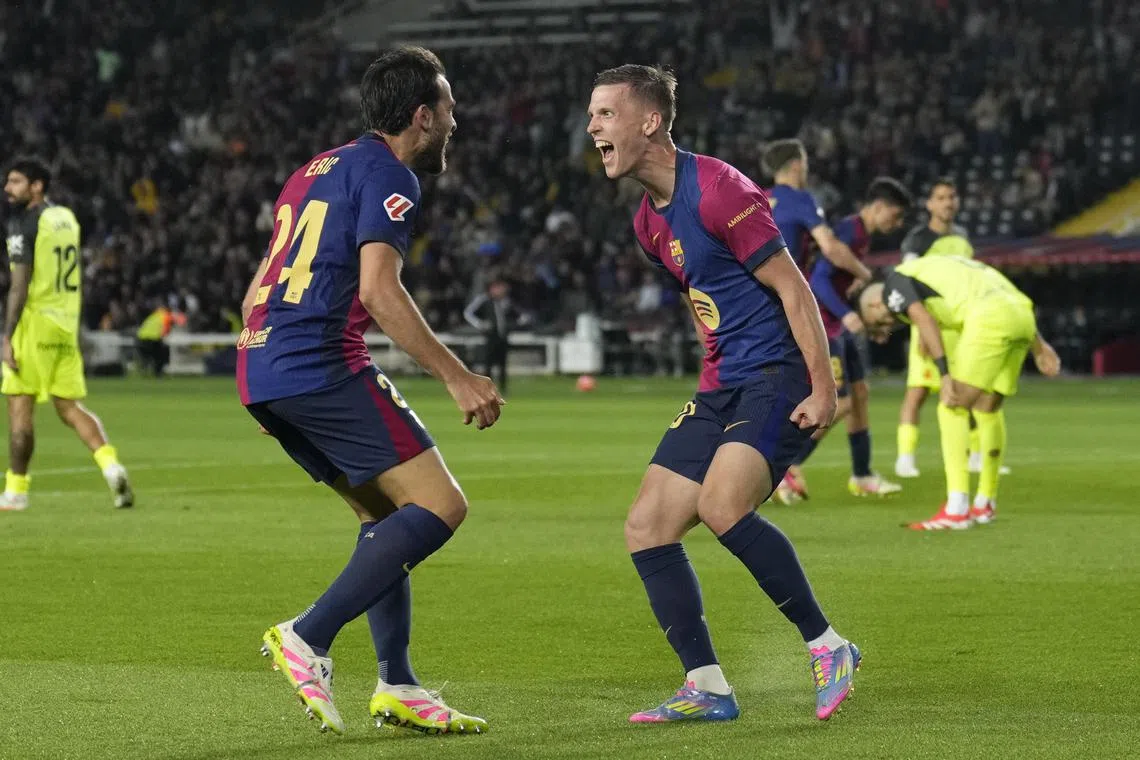 Barcelona's Dani Olmo (right) celebrates after scoring in the 1-0 La Liga win over Mallorca on April 22.