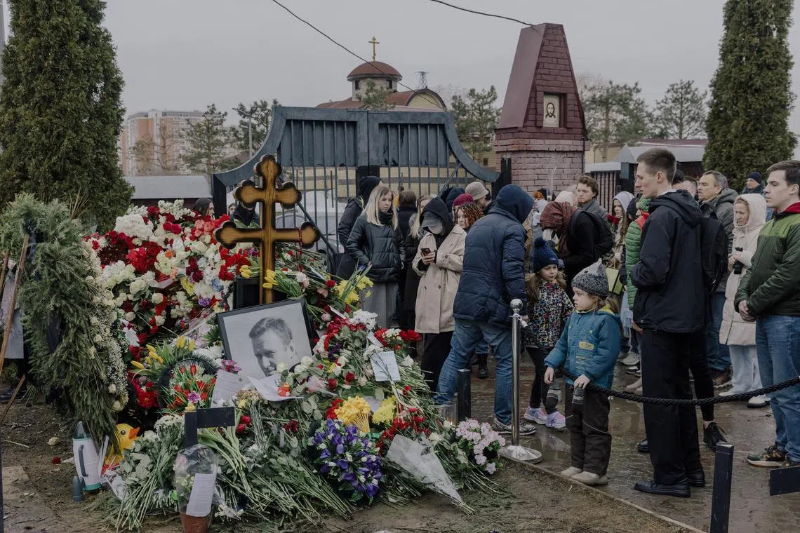 Mourners at the grave of Mr Navalny in Moscow on March 17, 2024.  
