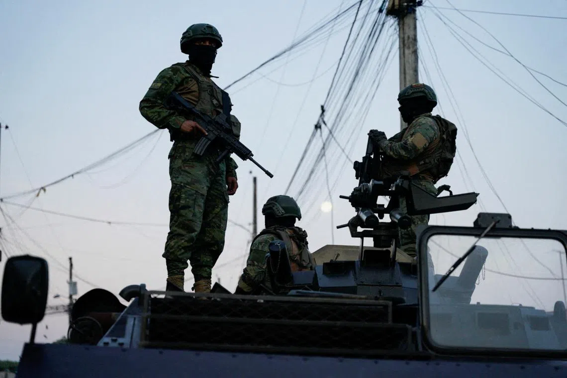FILE PHOTO: Soldiers atop an armoured vehicle stand guard during a joint military and police operation in the Socio Vivienda neighborhood, in Guayaquil, Ecuador March 26, 2024. REUTERS/Santiago Arcos/File Photo