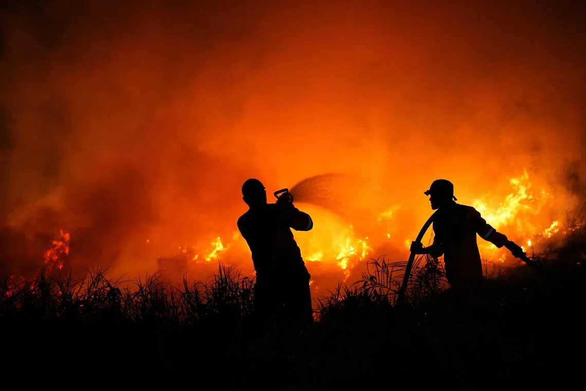 Indonesia escalates battle against fires, putrid haze