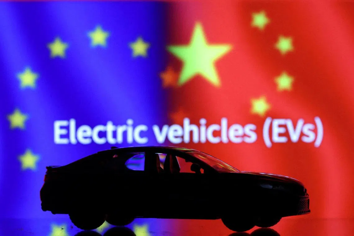 FILE PHOTO: Car miniature, "Electric vechicles (EVs)" words, EU and Chinese flags are seen in this illustration taken, September 26, 2023. REUTERS/Dado Ruvic/Illustration/File Photo
