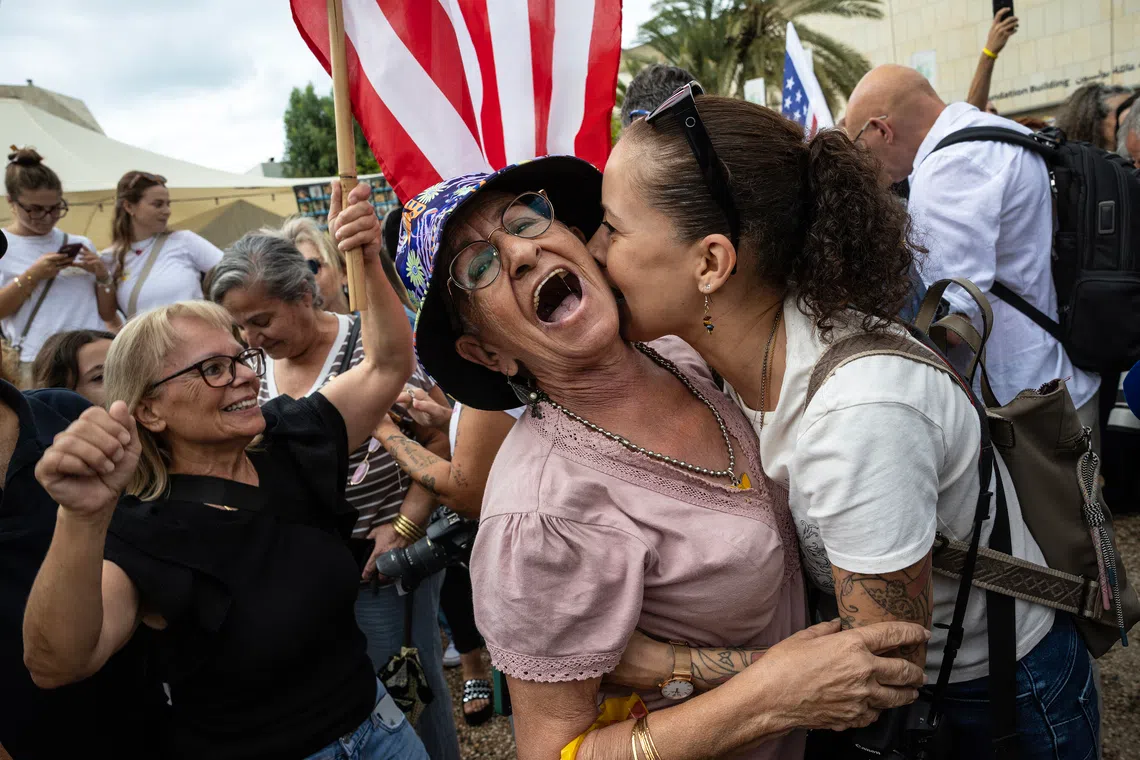 Israelis embrace and celebrate at Hostages Square in Tel Aviv, Israel, on Oct 9.