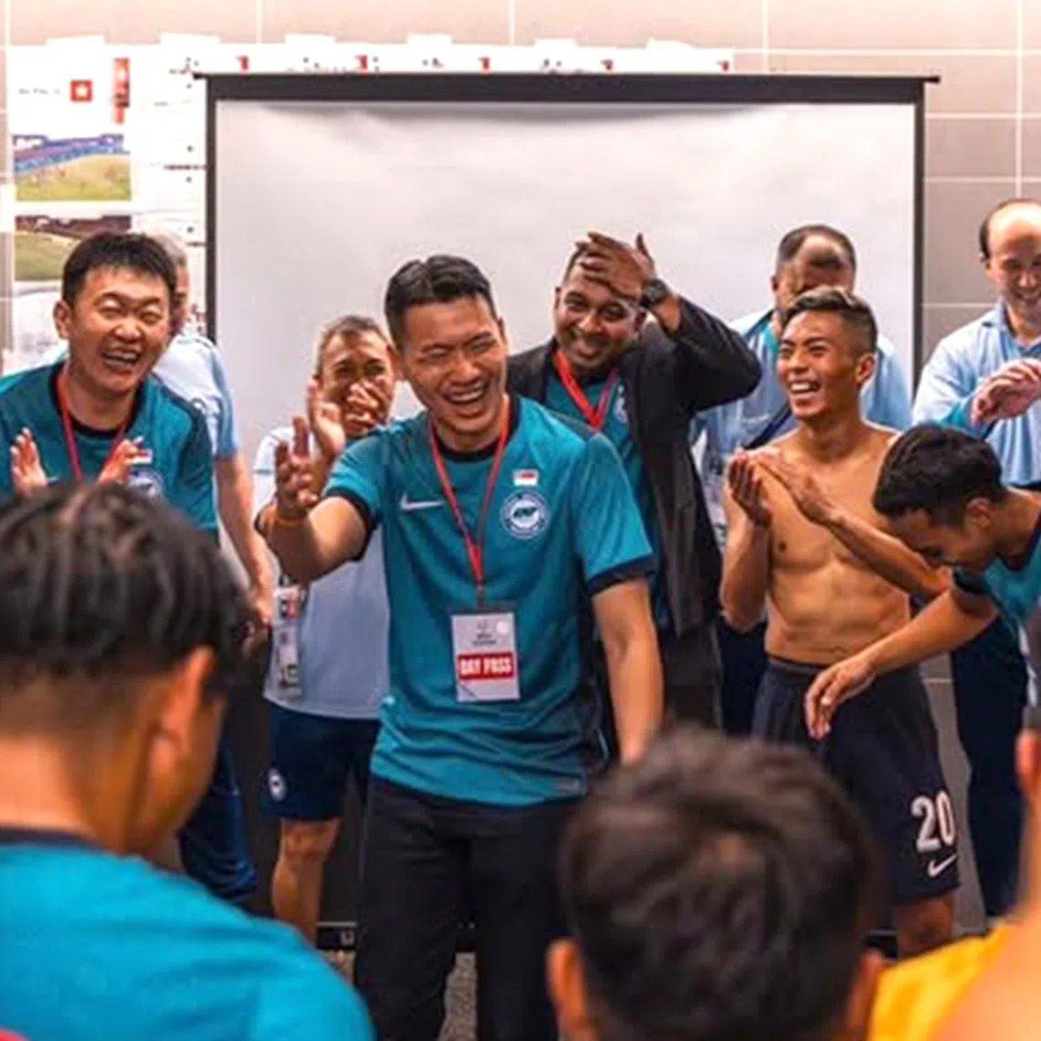 Acting Minister for Culture, Community and Youth David Neo addressing Singapore's national football team following their 2-1 away win over Hong Kong on Nov 18.