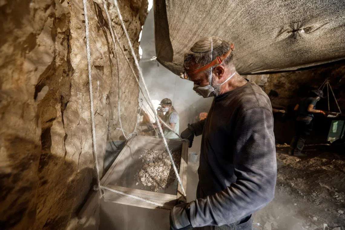 Excavators work inside Muraba'at Cave, a desert cliff excavation overseen by the Israel Antiquities Authority, near the Dead Sea, in the Israeli-occupied West Bank December 28, 2022. 