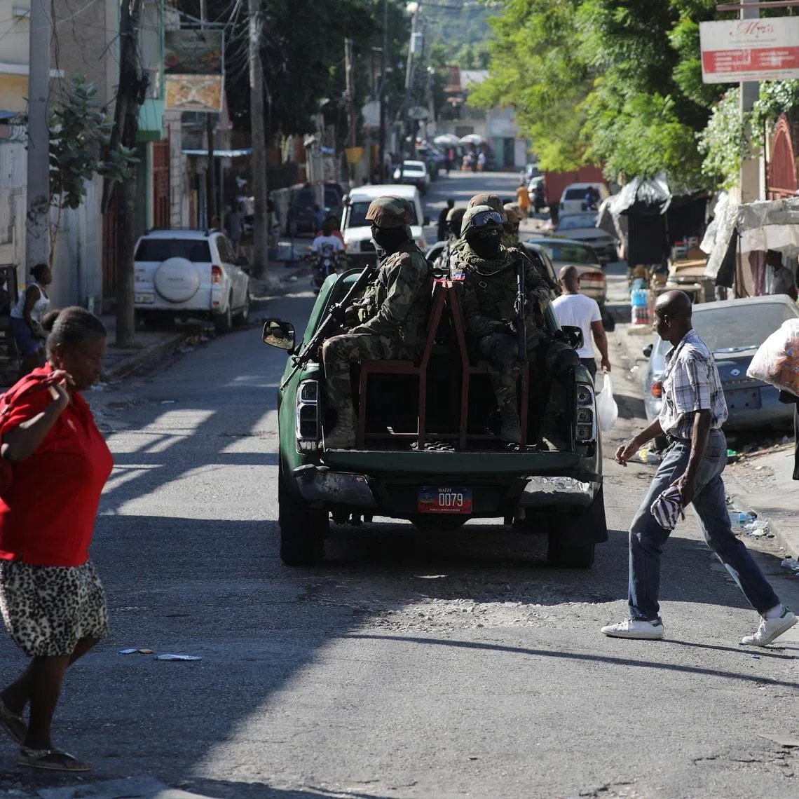FILE PHOTO: Members of the Haitian Armed Forces patrol the area as people flee homes following the armed gangs violence over the weekend, many grouped behind an alliance known as Viv Ansanm, at the Poste Marchand suburb, in Port-au-Prince, Haiti December 9, 2024. REUTERS/Ralph Tedy Erol/File Photo