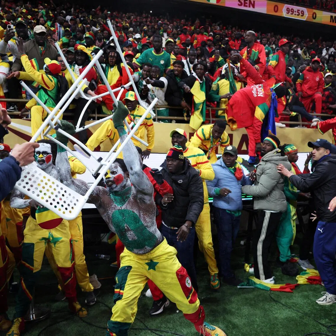 A Senegal fan clashing with security as supporters invade the pitch after Morocco were awarded a penalty following a VAR review in the Africa Cup of Nations final at the Stade Prince Moulay Abdallah in Rabat on Jan 18.  Senegal eventually won the match 1-0 in extra time.