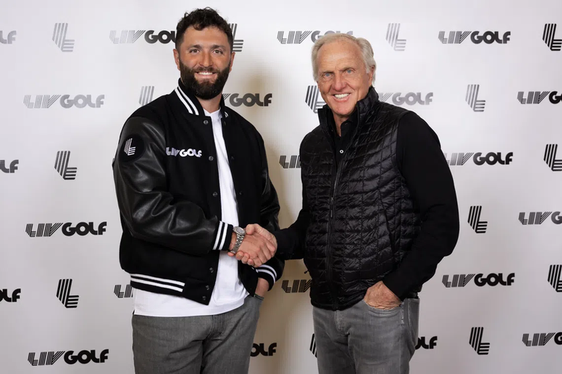 Two-time major winner Jon Rahm and LIV Golf commissioner and CEO Greg Norman shaking hands during a LIV Golf announcement at the Park Hyatt New York.