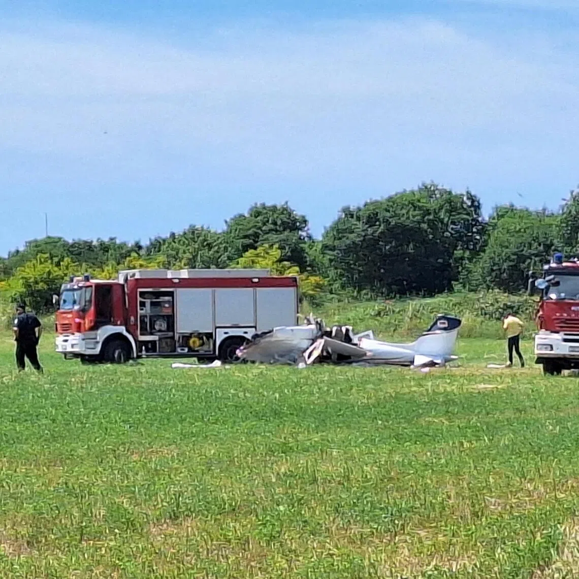 Rescue workers standing next to a small plane that crashed in the northwestern Croatian region of Istria, near the Adriatic town of Medulin, on June 4.