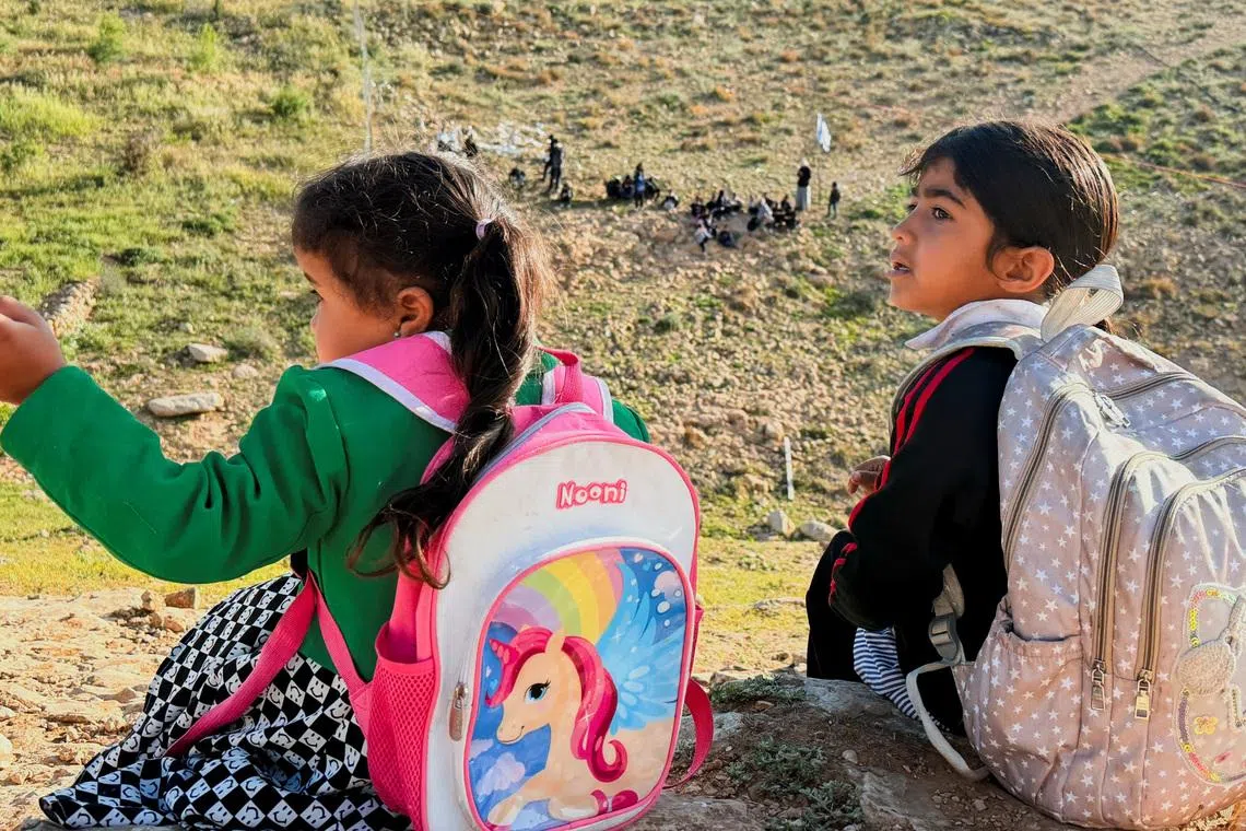 Palestinian students gather near a fence installed by Israeli settlers in their way to school, near Umm al-Khair village in Masafer Yatta, in the Israeli-occupied West Bank, April 14, 2026. Picture taken with a mobile phone. REUTERS/Yosri Aljamal