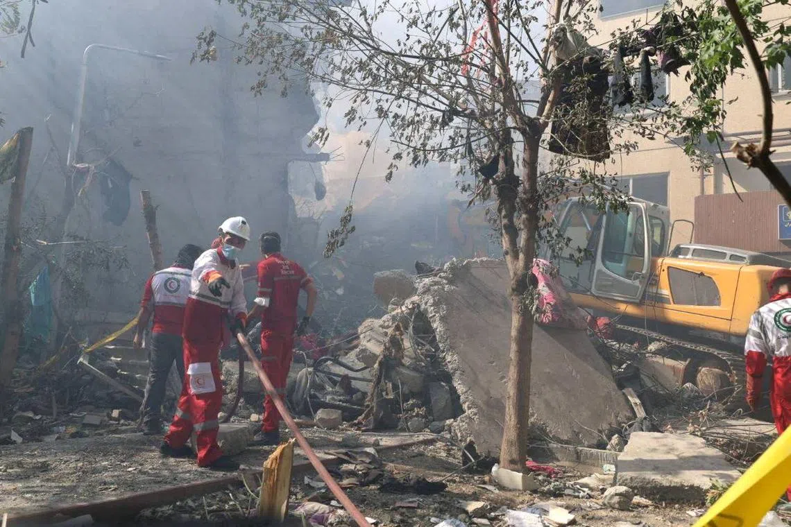 Rescuers work at the site of a damaged building, in the aftermath of Israeli strikes, in Tehran, Iran, June 13, 2025. Iranian Red Crescent Society/WANA (West Asia News Agency)/Handout via REUTERS