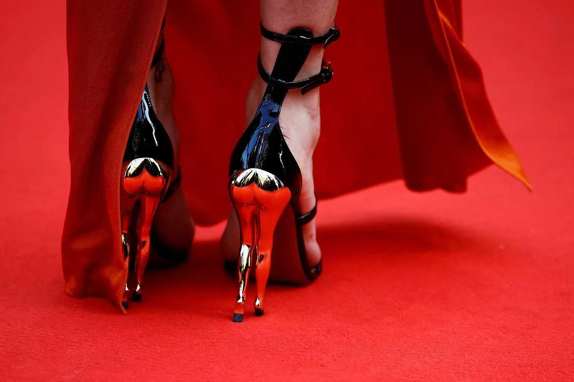 The shoes of a guest are seen in detail at a screening of the film "Firebrand" (Le jeu de la reine) at The 76th Cannes Film Festival in France, May 21. 