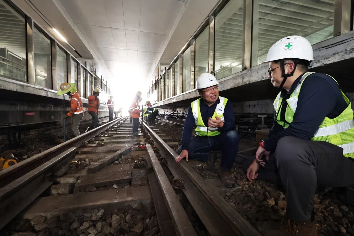 Mr Chia Choon Poh (second from right), LTA’s group director of rail (electrical and mechanical), with Mr William Low, LTA’s executive project engineer, checking out the progress of works to connect the East-West Line to the new East Coast Integrated Depot on Nov 30.