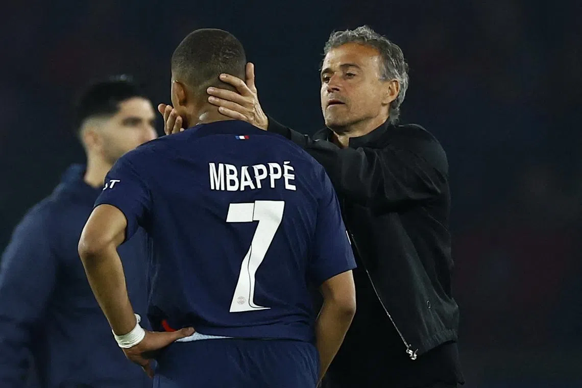 FILE PHOTO: Soccer Football - Champions League - Semi Final - Second Leg - Paris St Germain v Borussia Dortmund - Parc des Princes, Paris, France - May 7, 2024 Paris St Germain coach Luis Enrique and Kylian Mbappe look dejected after the match REUTERS/Sarah Meyssonnier/File Photo