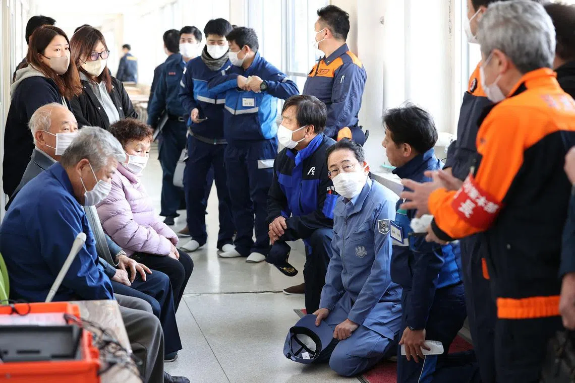 Mr Kishida (centre) listens to evacuees at an evacuation centre in Suzu city of Ishikawa prefecture.