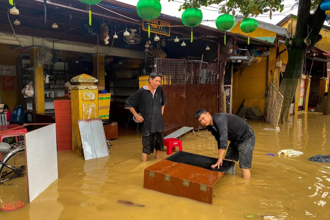 People clean their furniture in a flooded area in Hoi An, Vietnam on  Oct 31, 2025.  