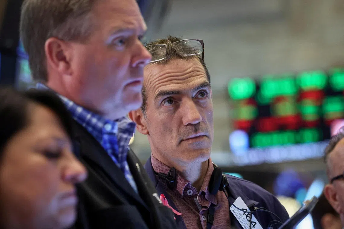 Traders work on the floor of the New York Stock Exchange, in New York City.