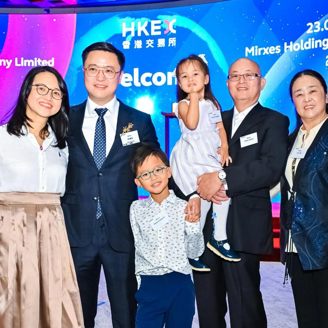Mirxes CEO Dr Zhou Lihan, his wife Yeap Su Phing, parents and two children at the Hong Kong Stock Exchange in Central after the Singapore biotech firm launched its IPO on May 23.