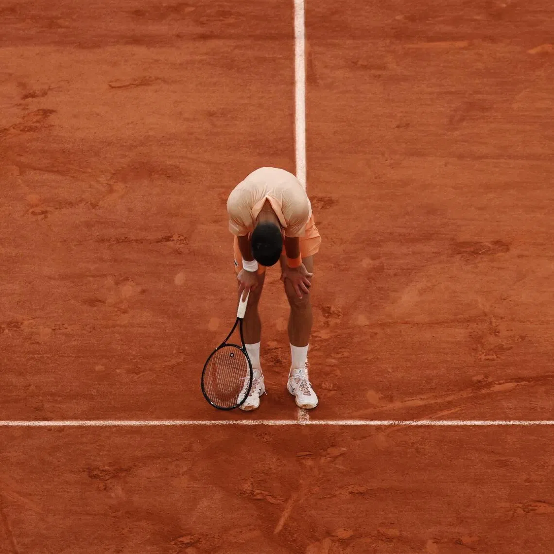 An exhausted Novak Djokovic during his five-set epic against Joao Fonseca at the French Open on May 29.