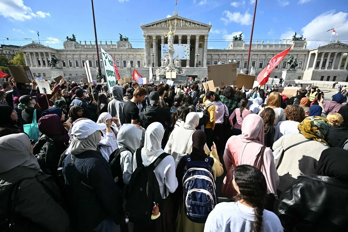 Protesters gather in front of the Austrian Parliament during a demonstration against a headscarf ban in schools on Oct 9.