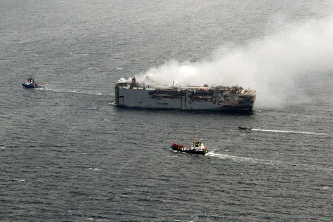 This handout photograph taken on Saturday and released a day later  by the Dutch coastguard shows smoke rising from the Panamanian-registered car carrier Fremantle Highway.