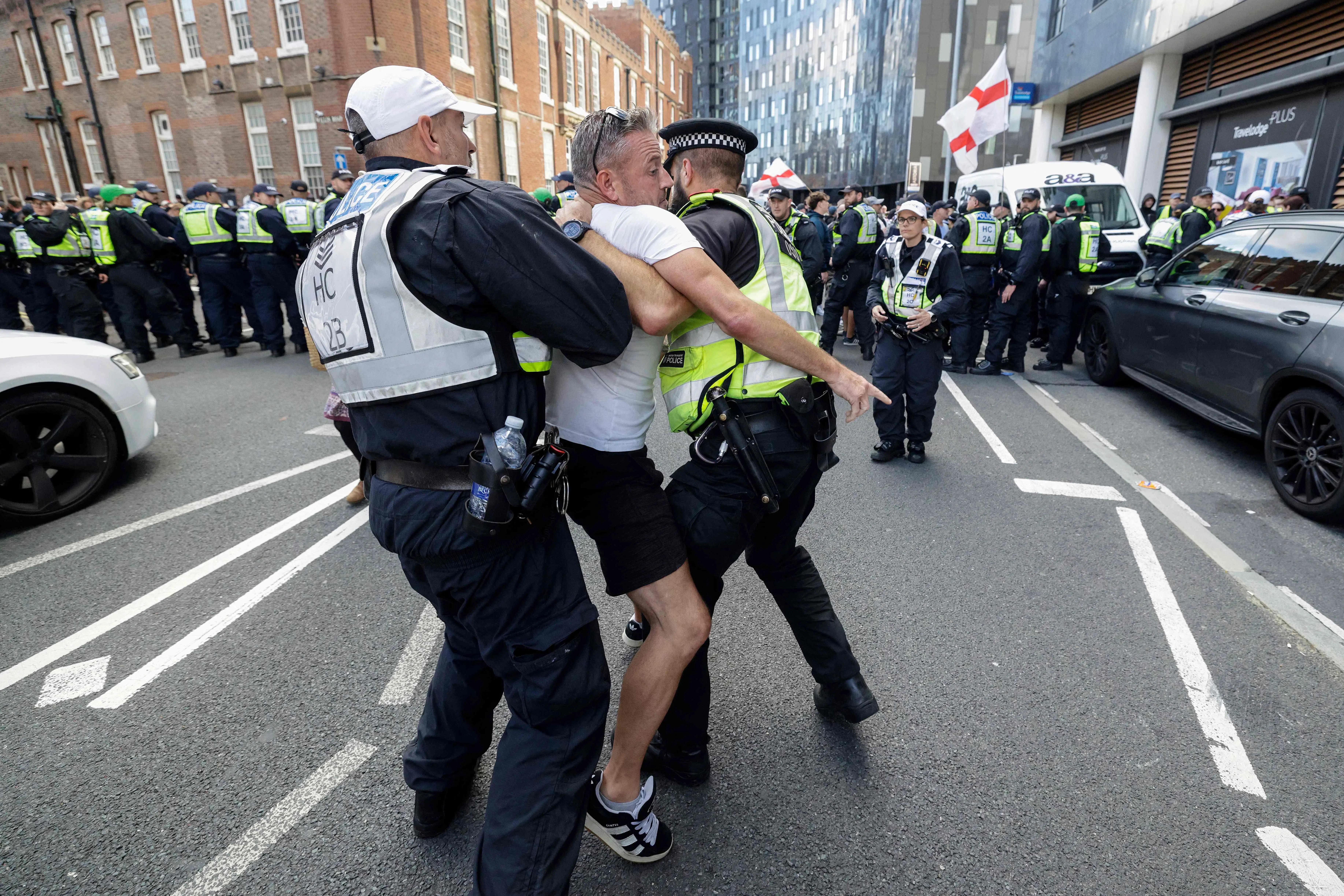 An anti-immigration demonstrator is detained by police in Portsmouth on Sept 12.