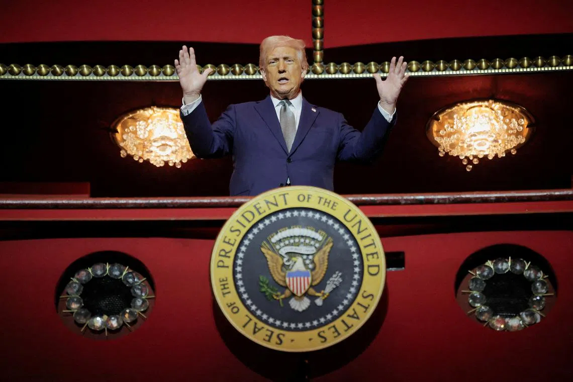 FILE PHOTO: U.S. President Donald Trump gestures while he poses for a picture at the presidential box at the Kennedy Center, in Washington, D.C., U.S., March 17, 2025. REUTERS/Carlos Barria/File Photo