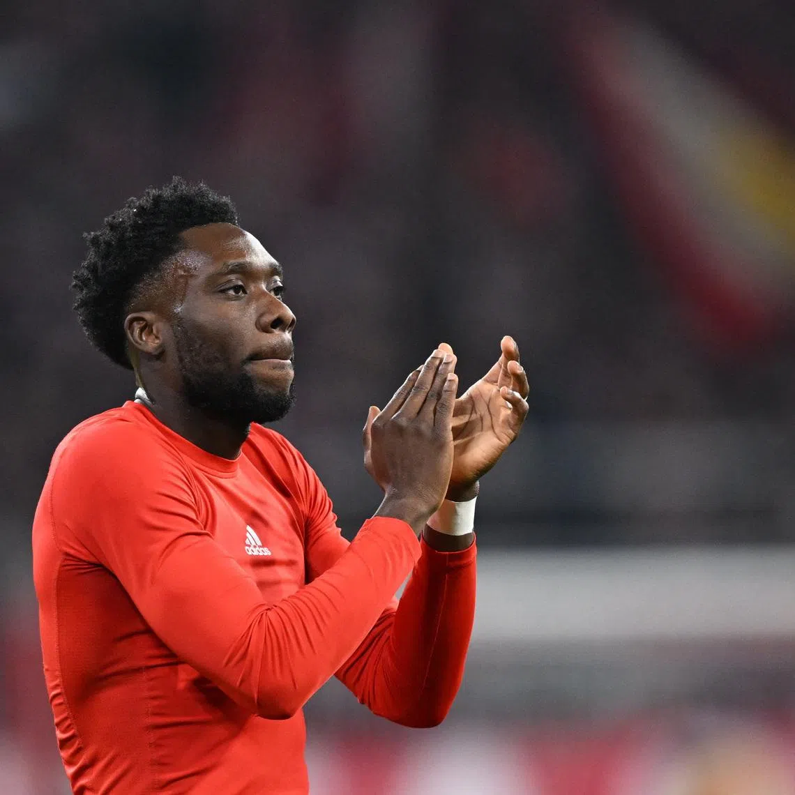 Soccer Football - UEFA Champions League - Bayern Munich v Sporting CP - Allianz Arena, Munich, Germany - December 9, 2025 Bayern Munich's Alphonso Davies celebrates after the match REUTERS/Angelika Warmuth