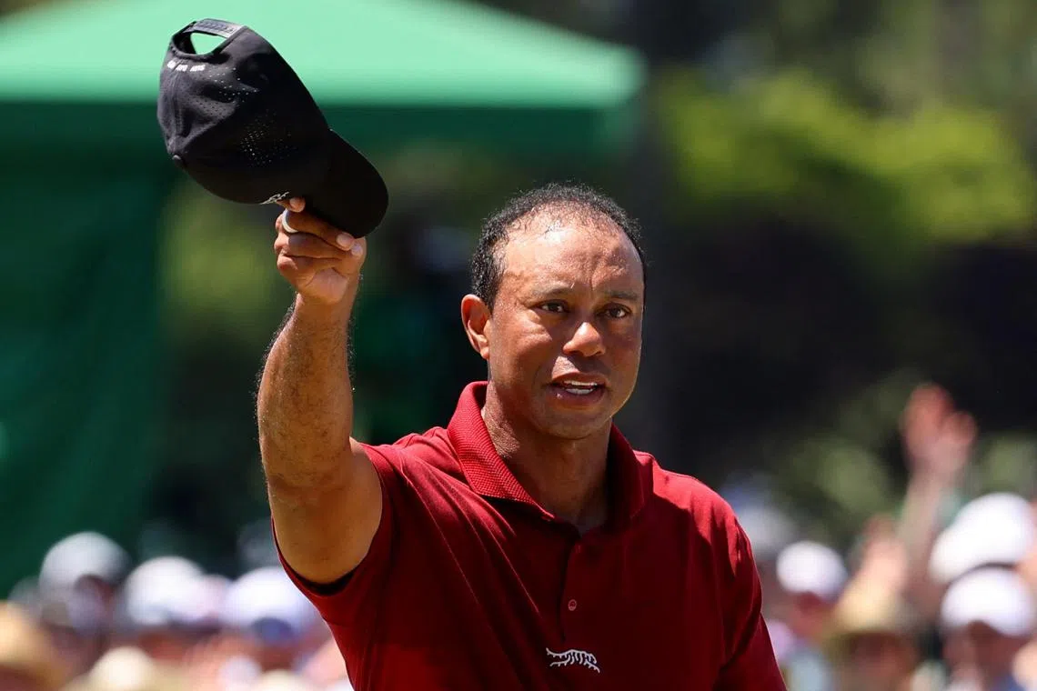 Tiger Woods acknowledges the crowd on the green on the 18th hole, after completing his final round.