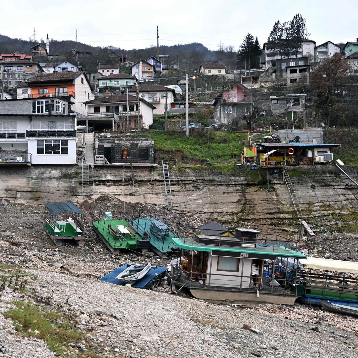 Boats and rafts on the shore of Lake Jablanicko, through which the Neretva River flows, near the Bosnian town of Konjic, on Dec 5.