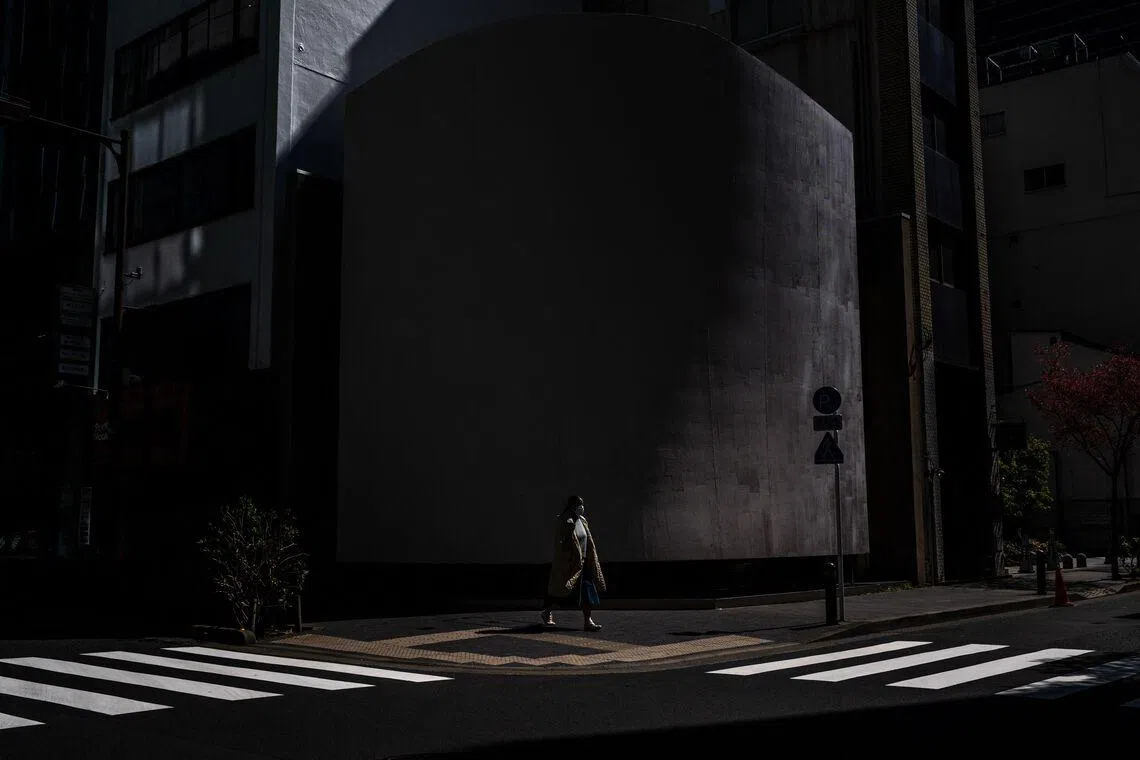 A woman walking at an intersection in the Chuo district of Tokyo on March 11.