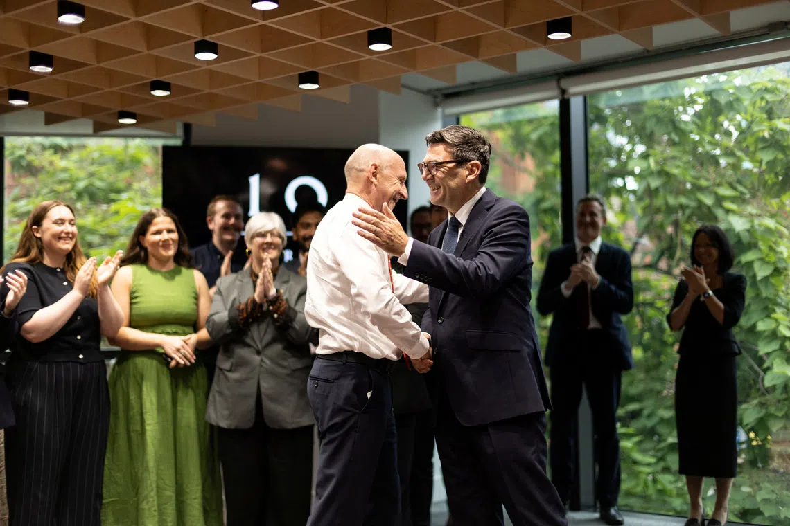 Britain's Prime Minister Andy Burnham shakes hands with Chancellor of the Exchequer John Healey, as he officially opens No. 10 North at Heron House, in Manchester, Britain, July 24, 2026. James Speakman/Pool via REUTERS
