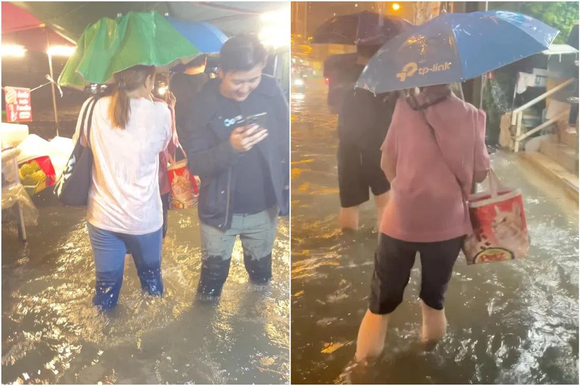 People wade through floodwaters after heavy rain in Bangkok on Sept 26.