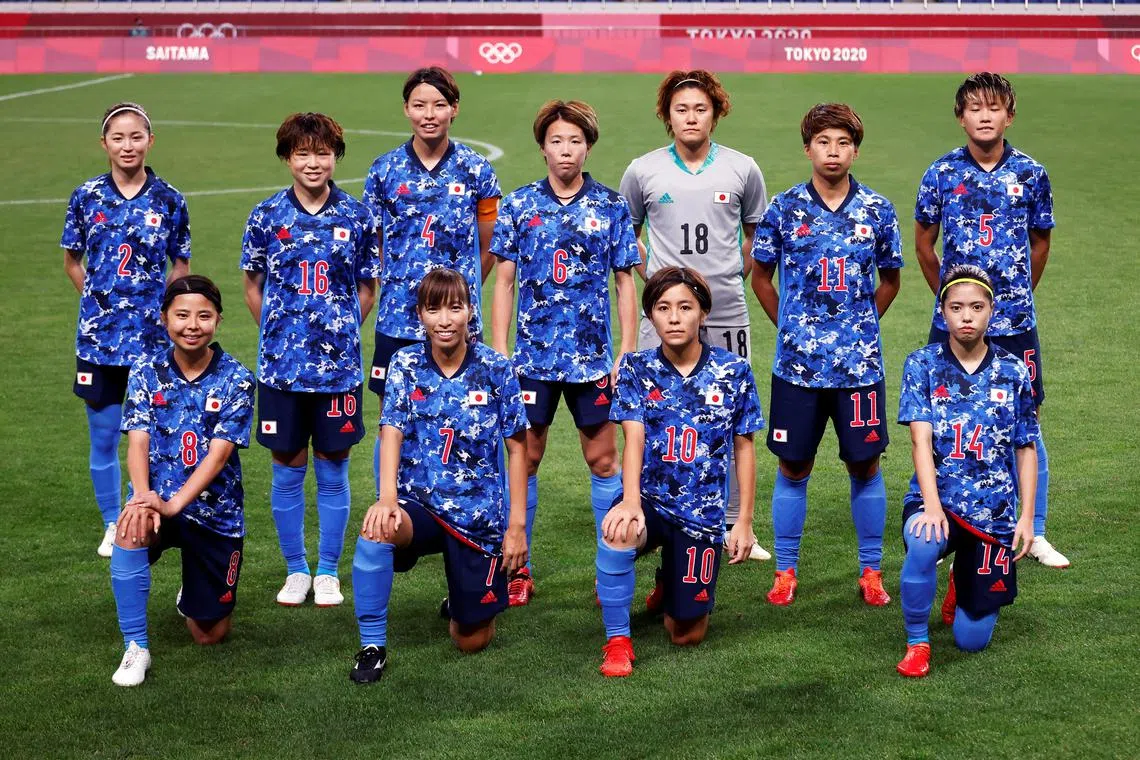 The Japanese women's football team posing for a photo before the quarter-final match against Sweden at the Tokyo Olympics.