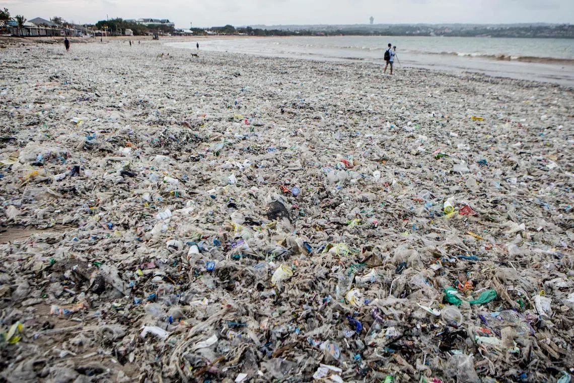 Marine debris and plastic waste washed ashore during the monsoon season covers Jimbaran Beach on Indonesia's resort island of Bali on March 10, 2026. 