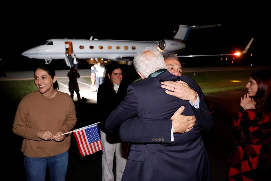 FILE PHOTO: Family members embrace freed Americans Siamak Namazi, Morad Tahbaz and Emad Shargi — as well as two returnees whose names have not yet been released by the U.S. government — who were released in a prisoner swap deal between U.S and Iran, as they arrive at Davison Army Airfield at Fort Belvoir, Virginia, U.S., September 19, 2023. REUTERS/Jonathan Ernst/Pool/File Photo
