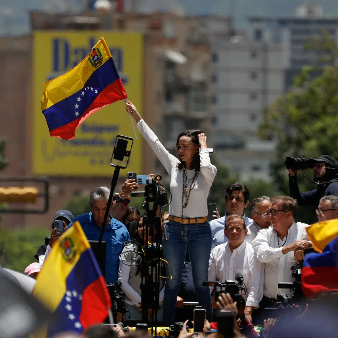 FILE PHOTO: Venezuelan opposition leader Maria Corina Machado waves a flag during a protest against the election results announced by President Nicolas Maduro's government after he was declared winner of the election, in Caracas, Venezuela August 28, 2024. REUTERS/Leonardo Fernandez Viloria/File Photo