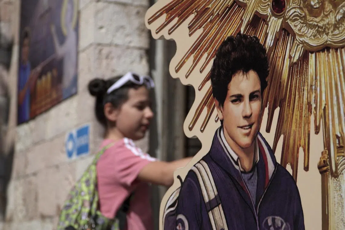 FILE PHOTO: A girl visits the tomb of Carlo Acutis, who died of leukemia in 2006 aged 15, in the Church of Santa Maria Maggiore in Assisi, Italy, May 26, 2024. Pope Francis has cleared the way for Acutis to be the first saint of the millennial generation. REUTERS/Matteo Berlenga/File Photo