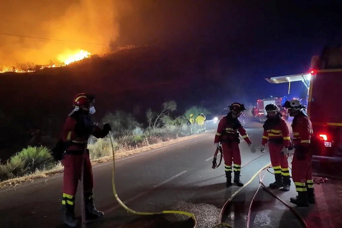 Firefighters work to control a wildfire in Almeria, Spain, on July 11.